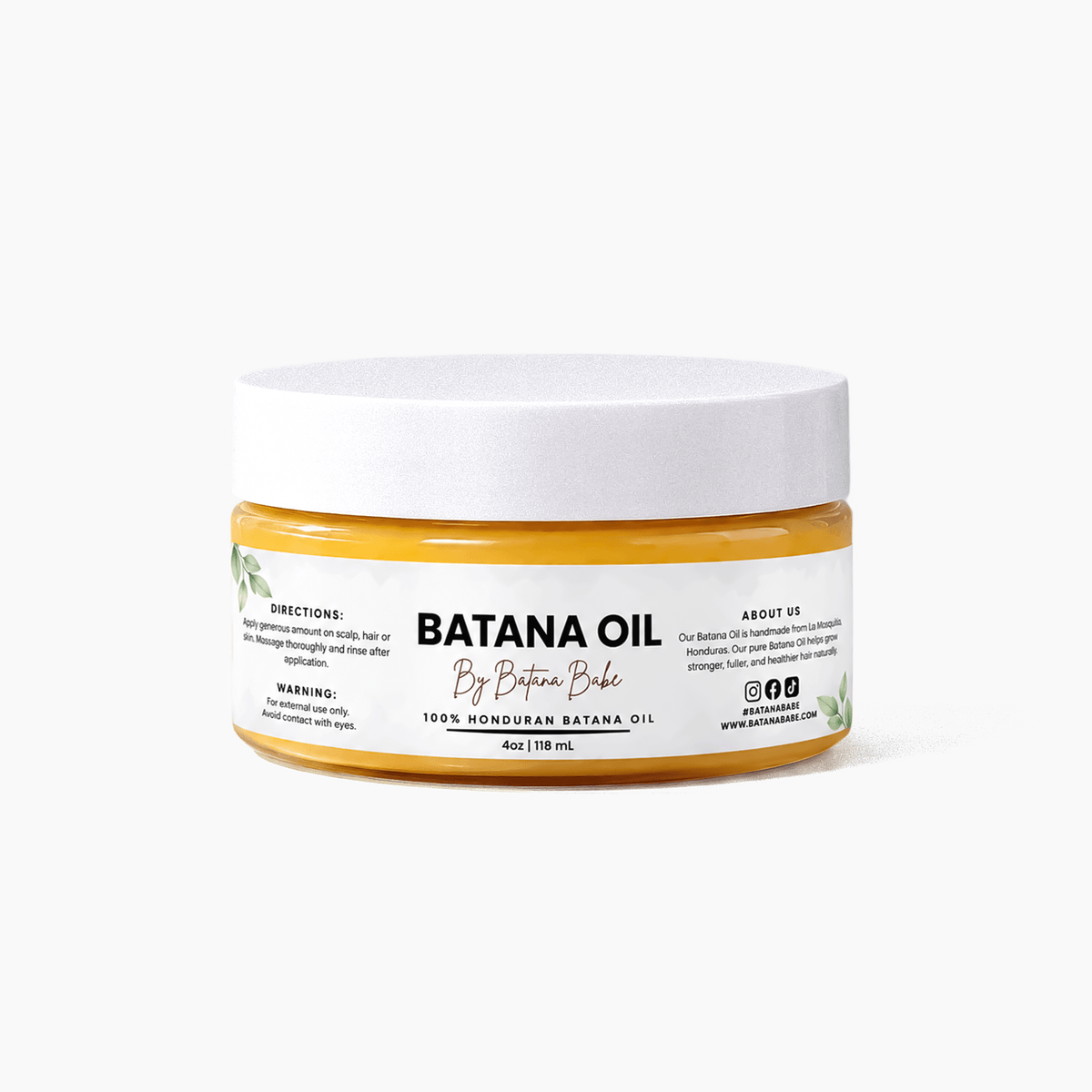 A jar of By Batana Bake Banana Oil hair mask on a clean white background. The product features a white lid and a clear jar showing the golden-yellow oil inside, with a white label displaying the brand name and product details.