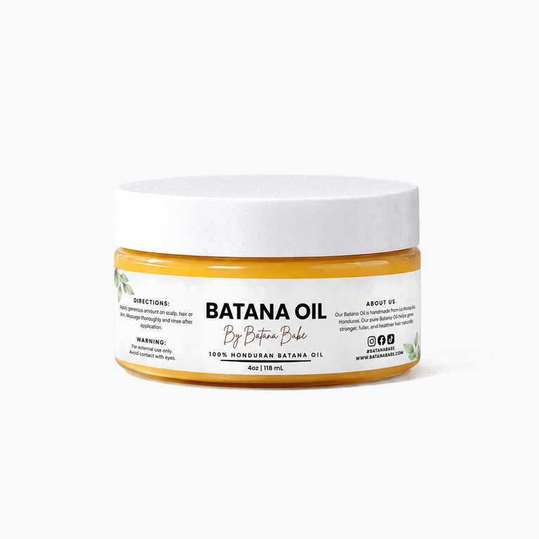 A jar of By Batana Bake Banana Oil hair mask on a clean white background. The product features a white lid and a clear jar showing the golden-yellow oil inside, with a white label displaying the brand name and product details.